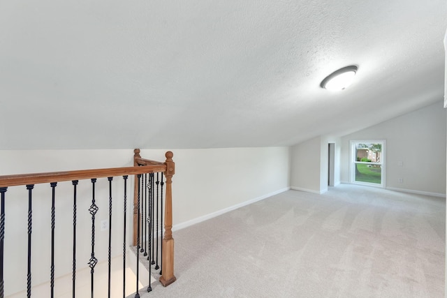 2897 Old Medina Rd, Jackson, TN 38305 - bonus room with vaulted ceiling, a textured ceiling, light carpet, and baseboards