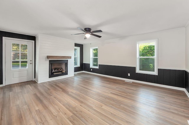 2897 Old Medina Rd, Jackson, TN 38305 - unfurnished living room with healthy amount of natural light, wood finished floors, a wainscoted wall, crown molding, and a ceiling fan
