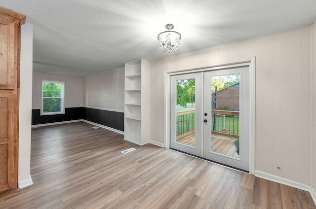 2897 Old Medina Rd, Jackson, TN 38305 - empty room featuring french doors, wood finished floors, a chandelier, and baseboards