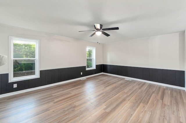 2897 Old Medina Rd, Jackson, TN 38305 - empty room featuring wainscoting, wood finished floors, and ceiling fan