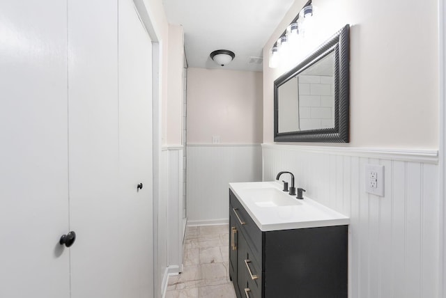 2897 Old Medina Rd, Jackson, TN 38305 - bathroom with vanity, marble finish flooring, and a wainscoted wall