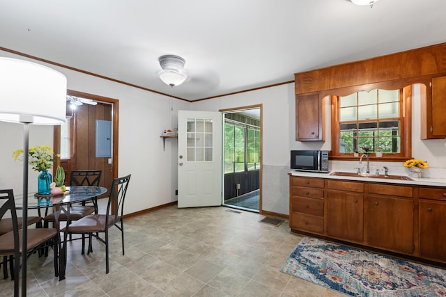 110 Rainbow Cir, Columbia, TN 38401 - kitchen featuring black microwave, a sink, brown cabinets, light countertops, and ornamental molding