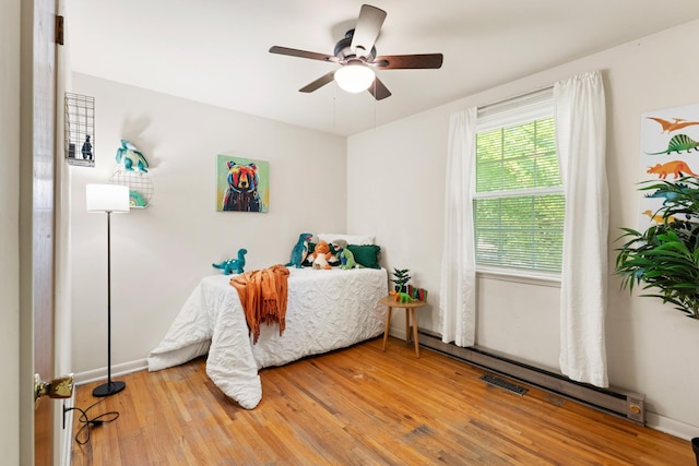 110 Rainbow Cir, Columbia, TN 38401 - bedroom featuring light wood-type flooring, a ceiling fan, baseboards, and a baseboard radiator