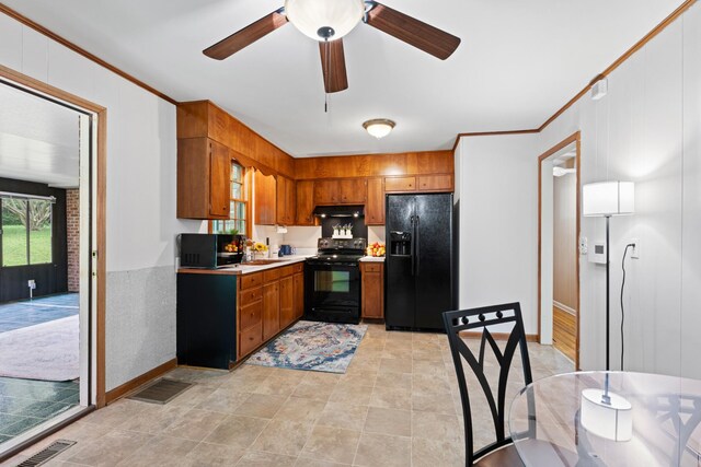 110 Rainbow Cir, Columbia, TN 38401 - kitchen with black appliances, brown cabinets, light countertops, under cabinet range hood, and crown molding
