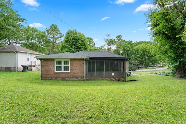 110 Rainbow Cir, Columbia, TN 38401 - rear view of house with a yard, brick siding, and a sunroom