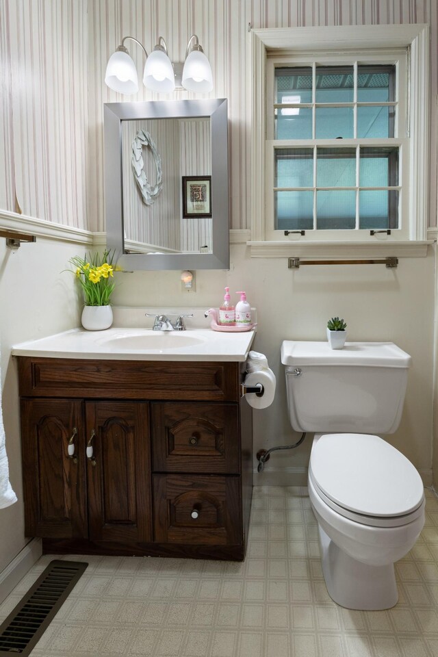 110 Rainbow Cir, Columbia, TN 38401 - bathroom featuring toilet, vanity, wallpapered walls, and baseboards