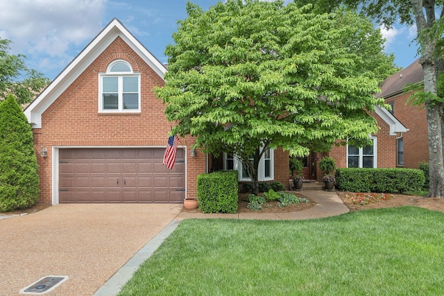 320 Julianna Cir, Franklin, TN 37064 - view of front of house featuring an attached garage, driveway, a front lawn, and brick siding