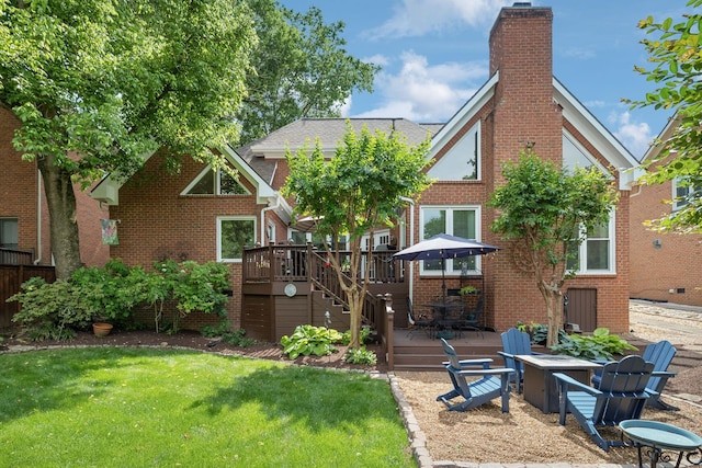 320 Julianna Cir, Franklin, TN 37064 - rear view of house with a deck, a fire pit, a chimney, and a lawn