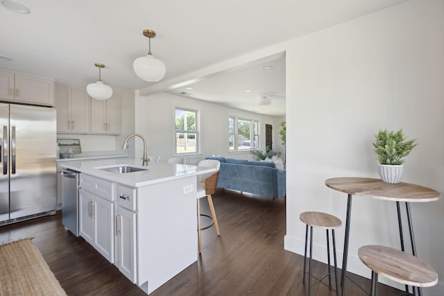 901 Elliston St, Old Hickory, TN 37138 - kitchen featuring appliances with stainless steel finishes, a sink, dark wood-style flooring, a kitchen bar, and light countertops