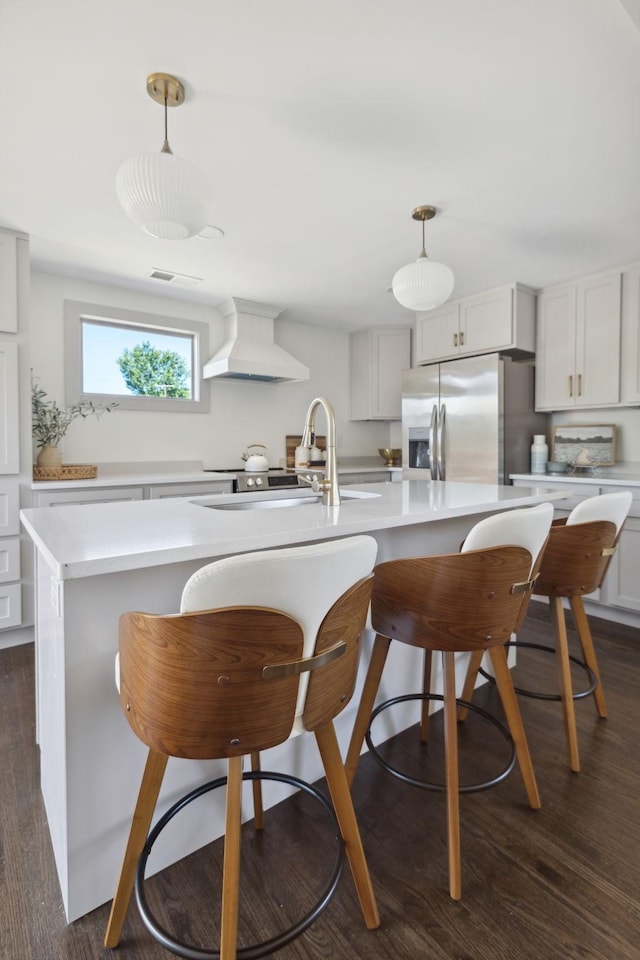 901 Elliston St, Old Hickory, TN 37138 - kitchen with custom exhaust hood, stainless steel fridge, light countertops, and dark wood-style flooring
