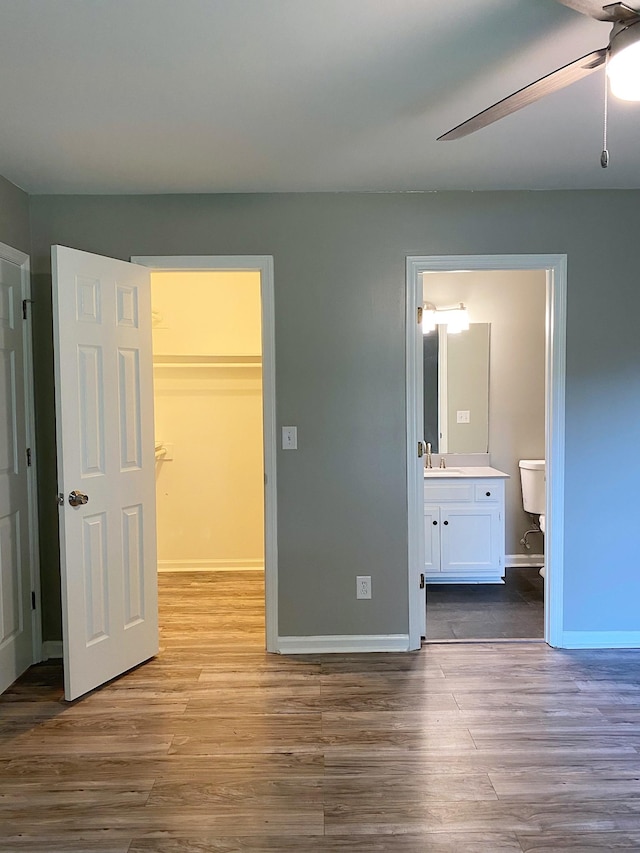 1834 Venada Trl, Murfreesboro, TN 37128 - unfurnished bedroom with a walk in closet, a sink, wood finished floors, and ensuite bathroom