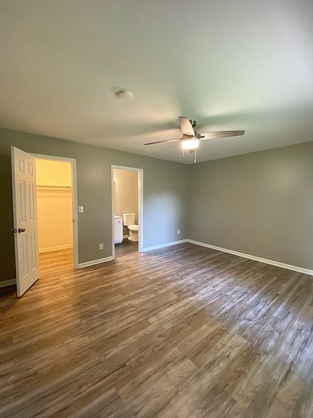 1834 Venada Trl, Murfreesboro, TN 37128 - unfurnished bedroom with dark wood-style flooring, baseboards, a spacious closet, ensuite bath, and a ceiling fan