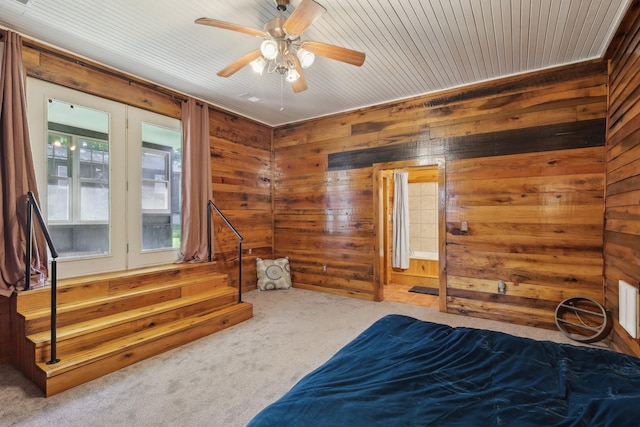 102 Nall Ave, Centerville, TN 37033 - carpeted bedroom with wood walls and ceiling fan