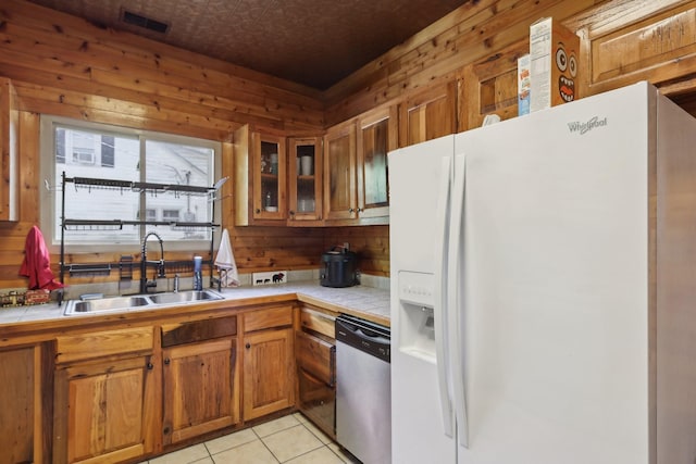 102 Nall Ave, Centerville, TN 37033 - kitchen featuring white refrigerator with ice dispenser, stainless steel dishwasher, a sink, tile countertops, and an ornate ceiling