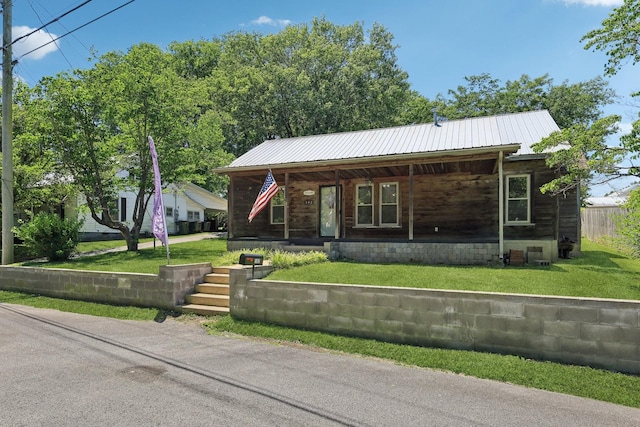 102 Nall Ave, Centerville, TN 37033 - view of front facade featuring covered porch, metal roof, and a front lawn