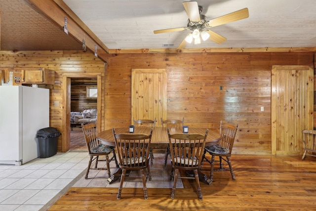 102 Nall Ave, Centerville, TN 37033 - dining space with wood walls, ceiling fan, and light wood-style flooring