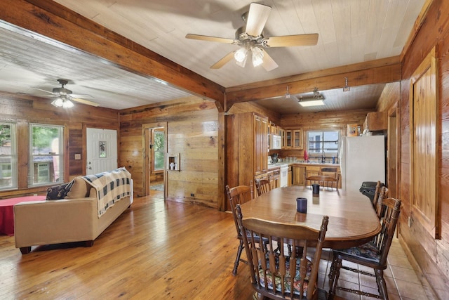 102 Nall Ave, Centerville, TN 37033 - dining area featuring a ceiling fan, wooden walls, beamed ceiling, and light wood finished floors
