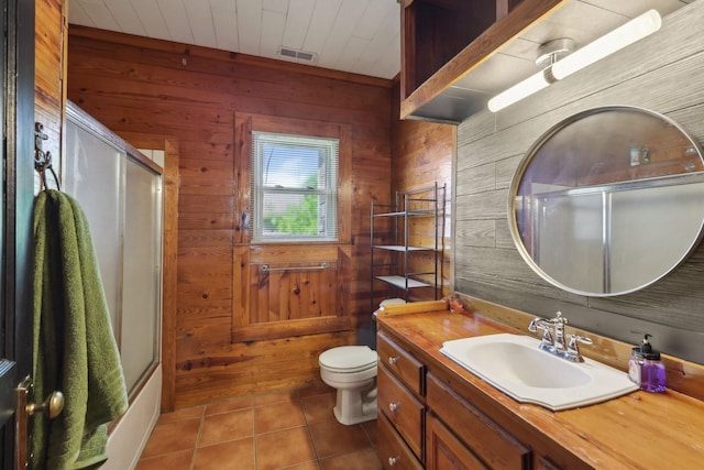 102 Nall Ave, Centerville, TN 37033 - bathroom with wooden walls, vanity, toilet, and tile patterned flooring