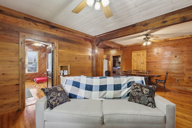 102 Nall Ave, Centerville, TN 37033 - living room featuring ceiling fan, wooden walls, hardwood / wood-style floors, and beamed ceiling