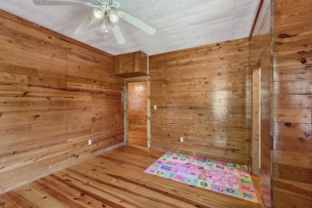 102 Nall Ave, Centerville, TN 37033 - empty room with wood walls, ceiling fan, and wood finished floors