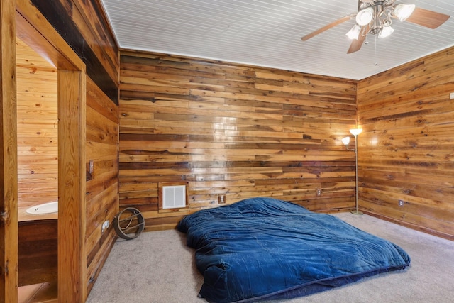 102 Nall Ave, Centerville, TN 37033 - carpeted bedroom featuring wooden walls and a ceiling fan