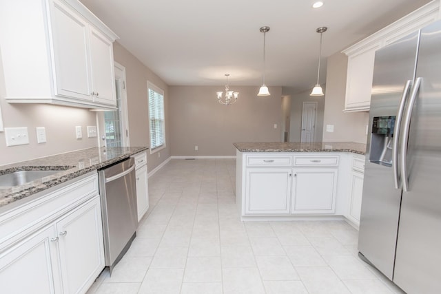 138 Beaver Creek Dr, Portland, TN 37148 - kitchen with appliances with stainless steel finishes, a peninsula, a chandelier, white cabinetry, and light tile patterned flooring