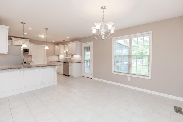 138 Beaver Creek Dr, Portland, TN 37148 - kitchen featuring stainless steel appliances, a sink, dark stone counters, recessed lighting, and a chandelier