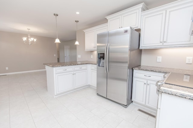 138 Beaver Creek Dr, Portland, TN 37148 - kitchen with stainless steel fridge with ice dispenser, a peninsula, a chandelier, white cabinetry, and pendant lighting