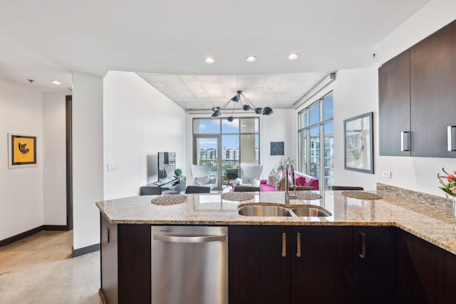 1510 Demonbreun St Unit 711, Nashville, TN 37203 - kitchen featuring a sink, recessed lighting, baseboards, light stone countertops, and open floor plan