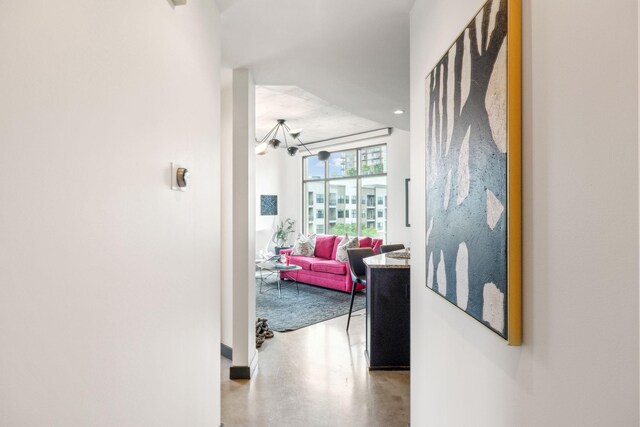 1510 Demonbreun St Unit 711, Nashville, TN 37203 - hall with a chandelier, finished concrete floors, and baseboards