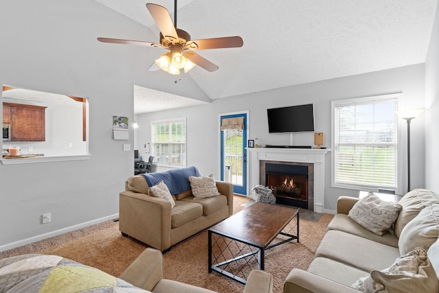 1382 Whitt Ln, Clarksville, TN 37042 - living area featuring vaulted ceiling, baseboards, ceiling fan, light colored carpet, and a fireplace