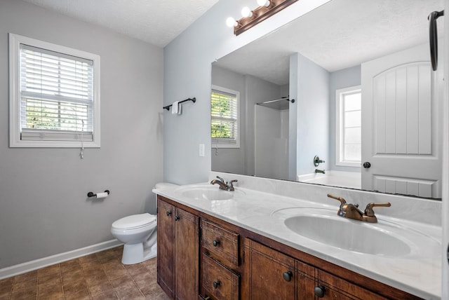 1382 Whitt Ln, Clarksville, TN 37042 - bathroom with baseboards, double vanity, toilet, a shower, and a textured ceiling