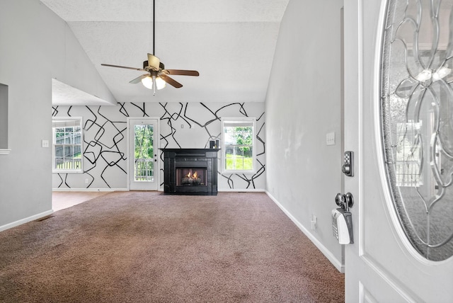 1382 Whitt Ln, Clarksville, TN 37042 - unfurnished living room featuring carpet flooring, a fireplace with flush hearth, ceiling fan, baseboards, and high vaulted ceiling