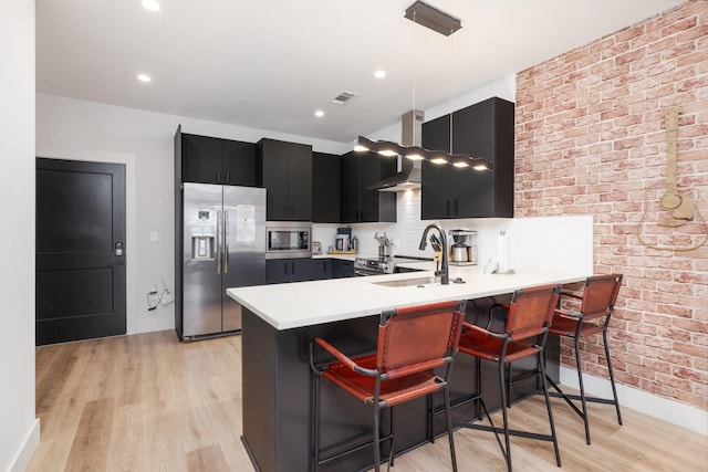 303 31st Ave N Unit 305, Nashville, TN 37203 - kitchen featuring appliances with stainless steel finishes, dark cabinets, a peninsula, baseboards, and light countertops