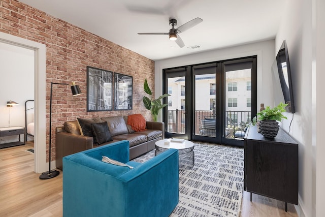 303 31st Ave N Unit 305, Nashville, TN 37203 - living area with brick wall, light wood-style flooring, and ceiling fan