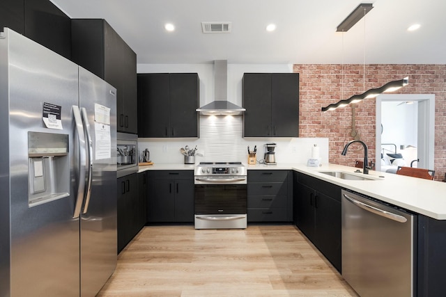 303 31st Ave N Unit 305, Nashville, TN 37203 - kitchen with appliances with stainless steel finishes, wall chimney exhaust hood, a sink, dark cabinetry, and light countertops