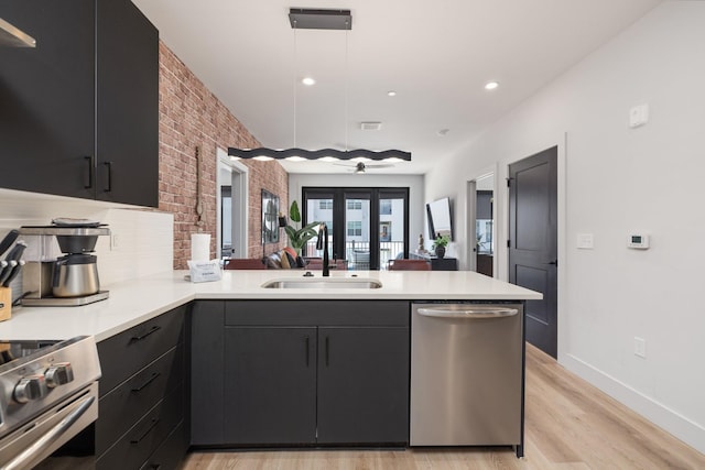 303 31st Ave N Unit 305, Nashville, TN 37203 - kitchen featuring appliances with stainless steel finishes, a sink, a peninsula, dark cabinets, and recessed lighting