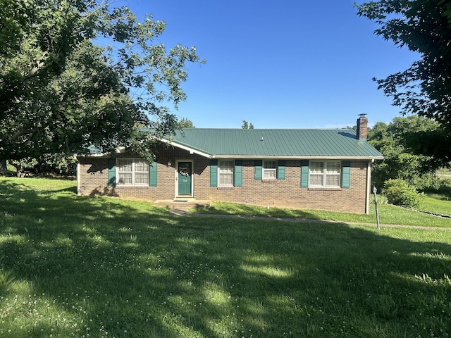 904 Cheairs Cir, Columbia, TN 38401 - ranch-style house with a front lawn, a chimney, metal roof, and brick siding