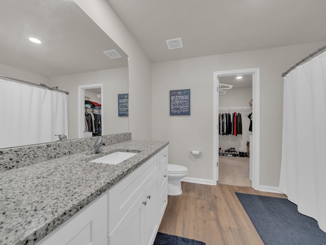 108 Birdie Ct, Dickson, TN 37055 - full bathroom featuring a walk in closet, vanity, toilet, wood finished floors, and baseboards