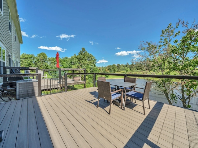 108 Birdie Ct, Dickson, TN 37055 - wooden terrace with outdoor dining space, central AC unit, and view of wooded area
