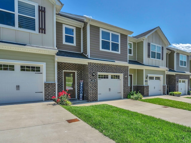 108 Birdie Ct, Dickson, TN 37055 - townhome / multi-family property with board and batten siding, a garage, brick siding, and driveway