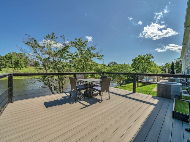 108 Birdie Ct, Dickson, TN 37055 - deck featuring central air condition unit, outdoor dining area, and a water view
