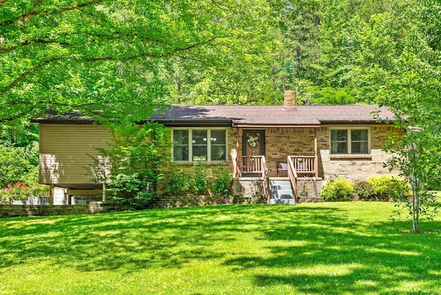 160 Terrapin Run Rd, Dover, TN 37058 - view of front of home with a front lawn, a chimney, and brick siding