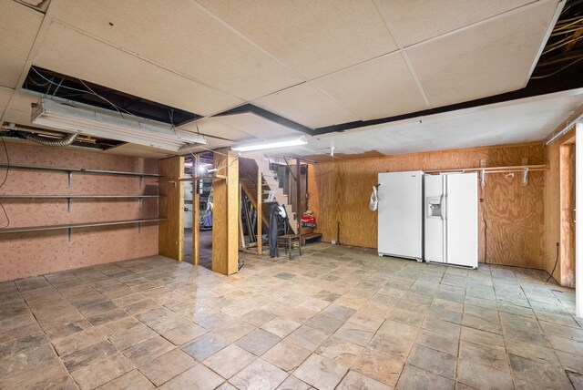 160 Terrapin Run Rd, Dover, TN 37058 - basement with stairway, white refrigerator with ice dispenser, and wood walls