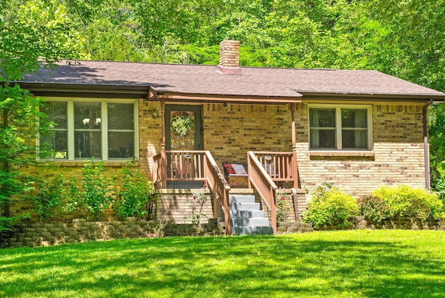 160 Terrapin Run Rd, Dover, TN 37058 - view of front of home with a chimney, a front yard, brick siding, and a shingled roof