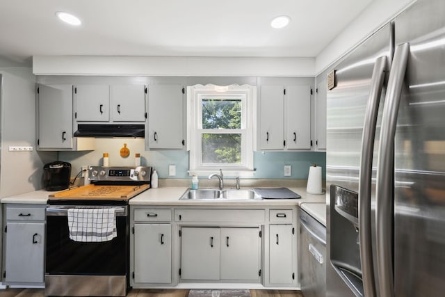 221 Cedar Creek Dr, Mount Juliet, TN 37122 - kitchen featuring appliances with stainless steel finishes, under cabinet range hood, a sink, light countertops, and recessed lighting