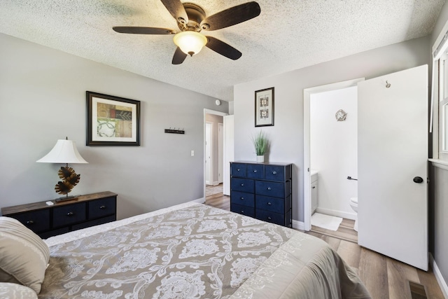 221 Cedar Creek Dr, Mount Juliet, TN 37122 - bedroom featuring wood finished floors, a textured ceiling, ensuite bath, baseboards, and a ceiling fan