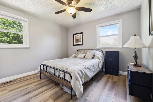 221 Cedar Creek Dr, Mount Juliet, TN 37122 - bedroom with a textured ceiling, wood finished floors, baseboards, and a ceiling fan