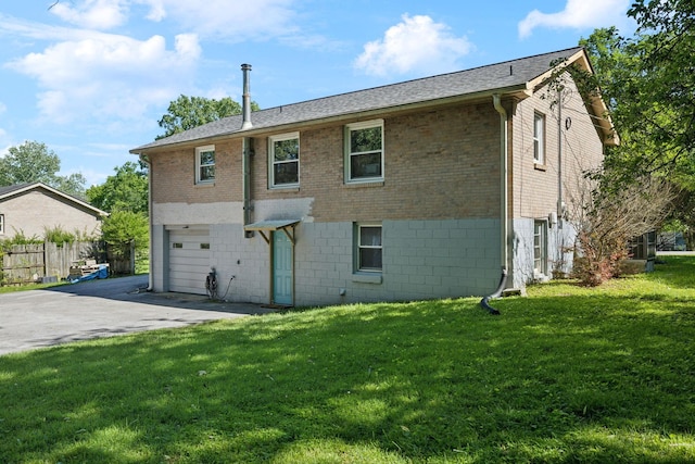 221 Cedar Creek Dr, Mount Juliet, TN 37122 - rear view of house with asphalt driveway, brick siding, an attached garage, and a yard