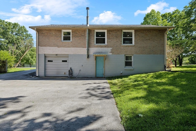 221 Cedar Creek Dr, Mount Juliet, TN 37122 - back of property with brick siding, a lawn, a garage, and driveway